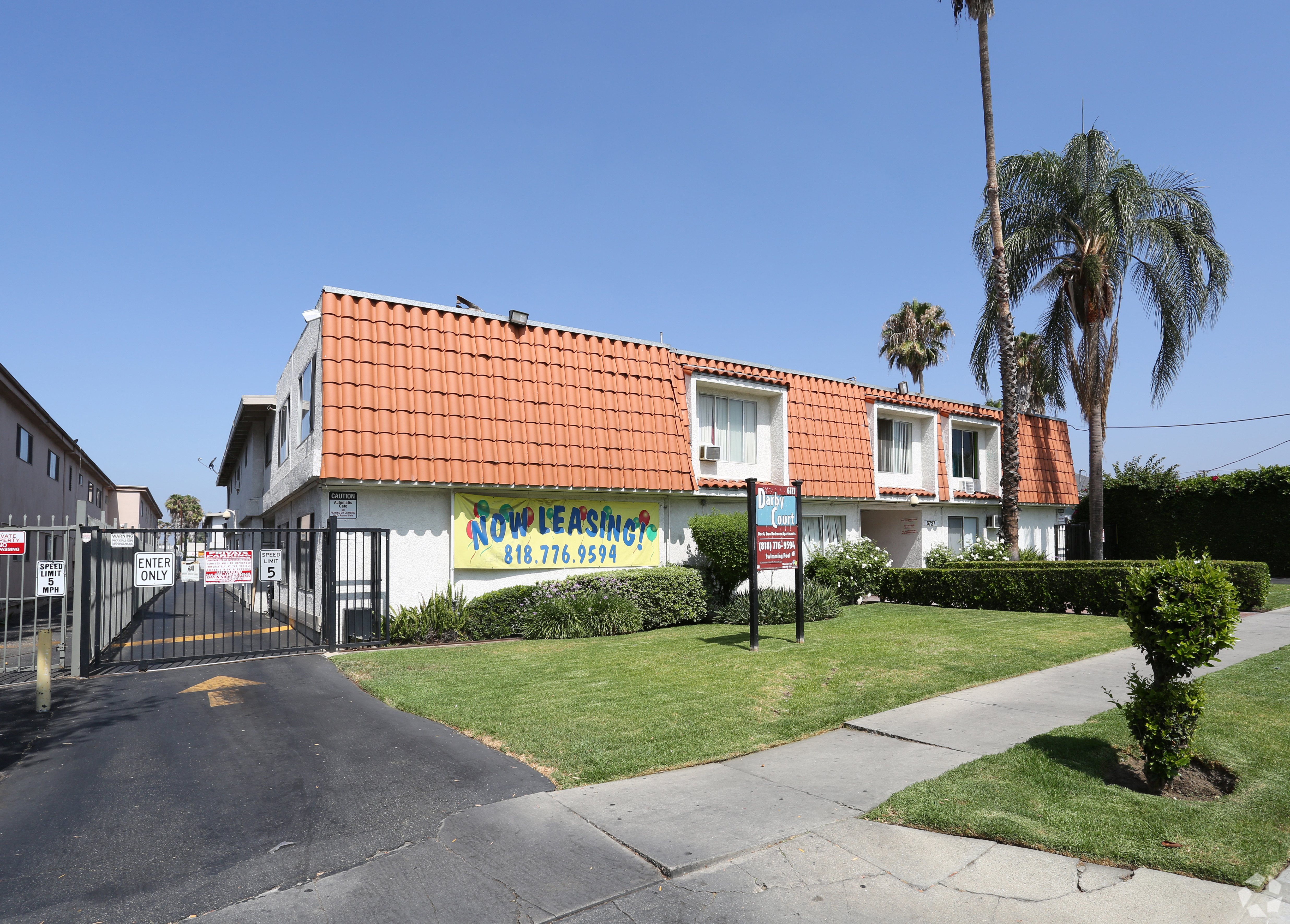 A building with a red roof and a sign that says "Row Leasing" is visible.